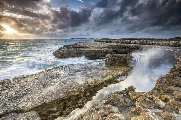 Rocks and crashing waves at Devils Bridge, a natural arch carved by the sea, Antigua