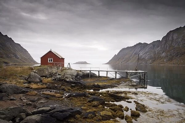 Rorbu (fishermans hut) and jetty on fjord, Lofoten Islands, Norway