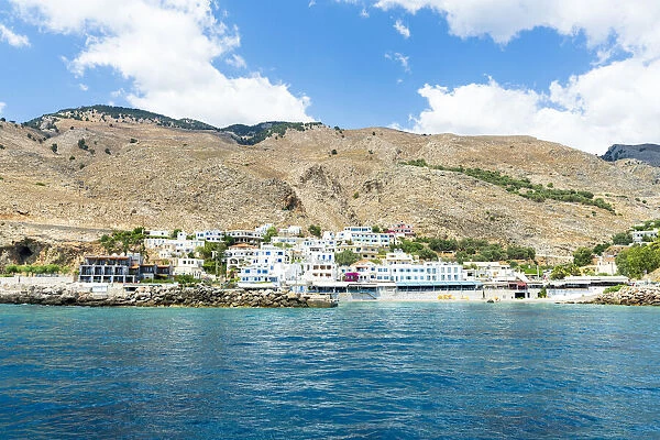Seaside town resort of Hora Sfakion view from boat trip in the blue sea, Crete island, Greek Islands, Greece, Europe