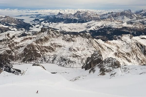 Skiers descend from the top of Marmolada in the Dolomites, Italy, Europe