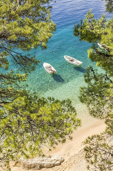 Two small boats anchored at Podrace Beach near Brela and Makarska, Croatia, Europe