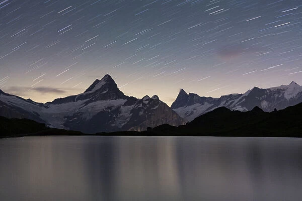 Star trail in the night sky over Bachalpsee lake, Grindelwald, Bernese Oberland