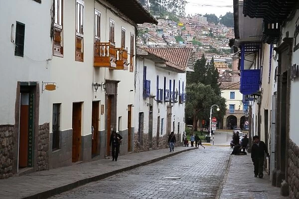 Side street in centre of Cusco City with outskirts of city on hill beyond, Cuzco
