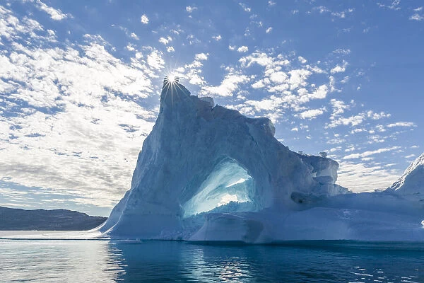 Sunburst on iceberg in Holms O, Baffin Bay, on the northwest coast of Greenland