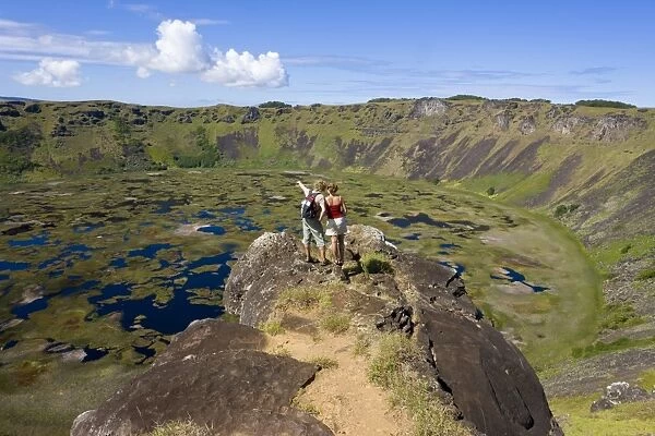 Tourists looking into the crater and view from the rim into the crater of Ranu Kau