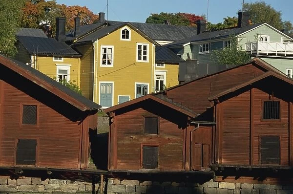 Typical heavy red of fishermens cottages and sheds lining the River Porvoo