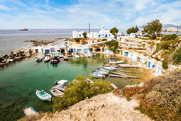 View over fishing harbour with boats and colourful boat houses, Mandrakia, Milos