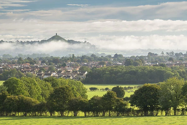 View across the town of Street towards Glastonbury Tor on a misty autumn morning