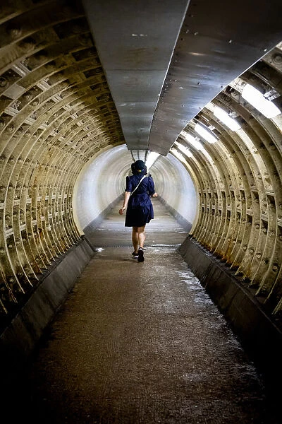 Woman walking through the Greenwich foot tunnel, Greenwich, London, England, United Kingdom, Europe