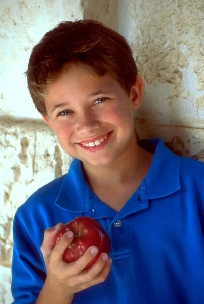 Boy holding apple