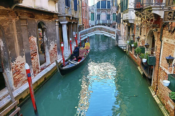 Deserted bridge over a canal with a gondola in Venice, Italy