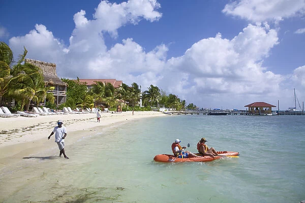 Belize, Ambergris Caye, San Pedro, Ramons Village Resort, Tourists sea kayaking