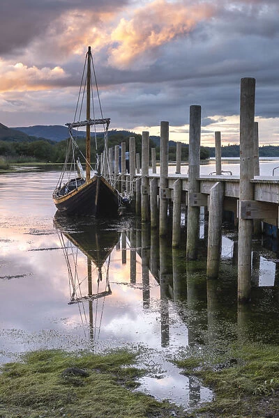 Boat and jetty at sunset on Derwent Water, Lake District, Cumbria, England