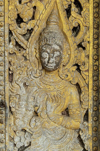 Carving on a door of a temple in Luang Prabang (ancient capital of Laos on the Mekong river), Laos