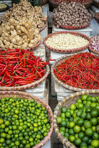 Chili peppers, limes, ginger and garlic for sale at Đồng Xuan