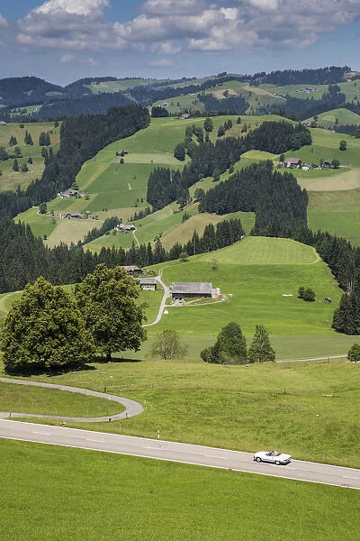 Convertible car on winding road in the Emmental Valley, Berner Oberland, Switzerland