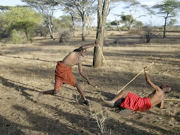 Two Datoga men participate in a mock stick fight