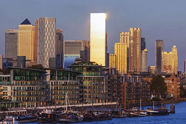 England, London, Docklands, Late Evening Light on Canary Wharf Skyline and River Thames