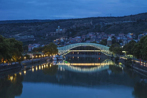 Georgia, Tbilisi, Peace bridge with Old Town and Narikala Fortress in background