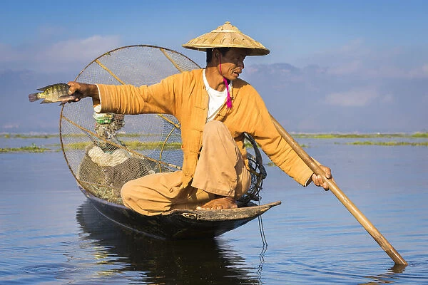 Intha fisherman with a traditional conical fishing net