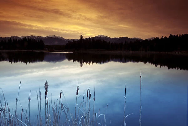Invermere, British Columbia. A dramatic morning sky reflected on a pond in the Canadian