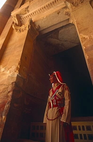 Jordan, Petra. A Jordanian policeman stands at the entrance to Petras famous Treasury