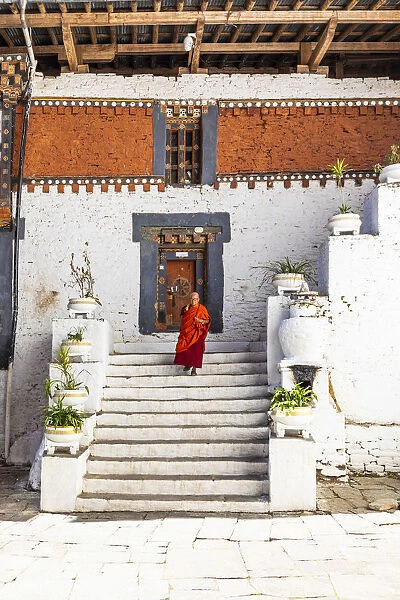 A monk walking in Trongsa Dzong, Trongsa District, Bhutan