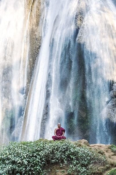 Myanmar, Mandalay division, Pyin Oo Lwin. Burmese monk meditating under Dattawgyaik Waterfall