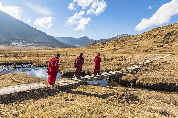 Novice Monks (Child Monks) crossing a river in Phobjikha Valley, Bhutan