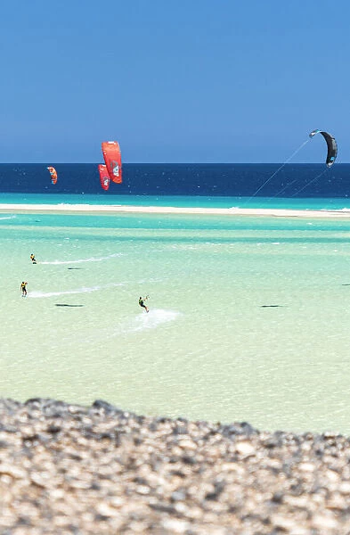 People having fun with kiteboard in the rough sea, Sotavento beach, Jandia, Fuerteventura