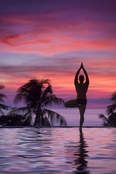 Philippines, Visayas, Boracay Island, Man practising Yoga (Tree Pose) at luxury resort