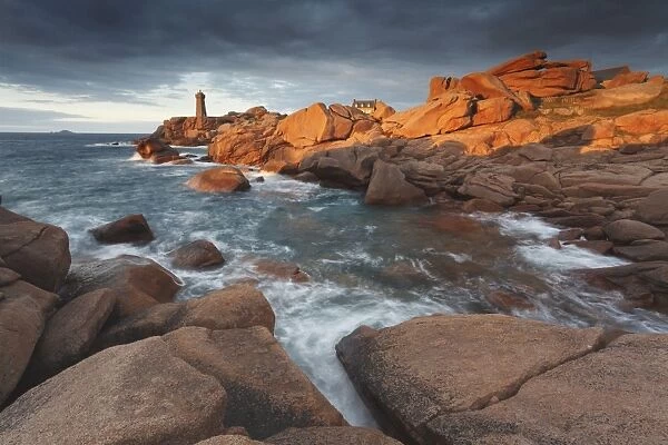 Pink Granite coast, Brittany, France. The Ploumanach lighthouse (Men Ruz) an sunset