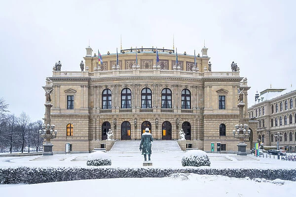 Snow-covered Antonin Dvorak statue in front of Rudolfinum concert hall in winter