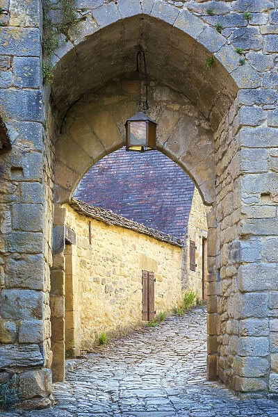 Stone arched passage along medieval alley in Beynac-et-Cazenac, Dordogne Department