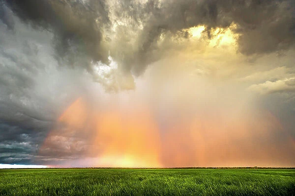 Storm clouds and rainbow over Swim Creek floodplain, Bamurru Plains, Northern Territory, Australia