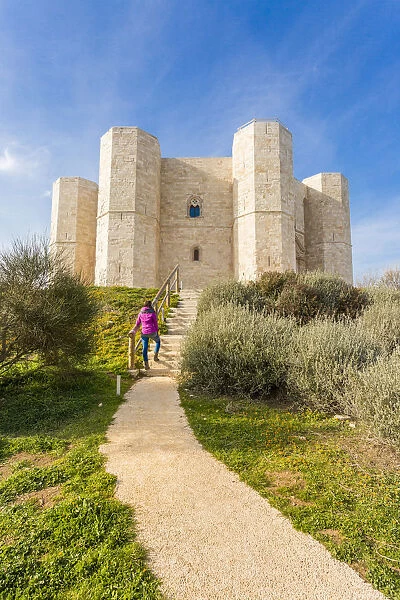 Tourist admiring Castel del Monte fortress in Andria, Apulia region, Italy (MR)