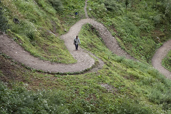 A tourist climbing the path to the Tango monastery near Thimpu, Bhutan