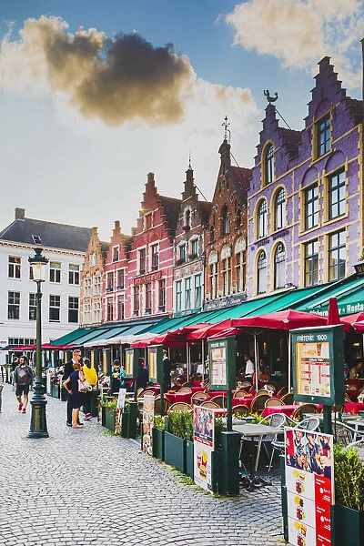 Tourists sitting in caf√® on Bruges main square, Belgium