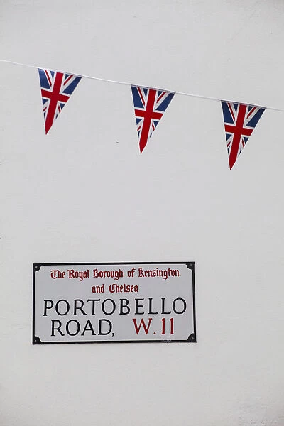 UK, England, London, Kensington, Union Jack bunting above Portobello Rd sign to celebrate