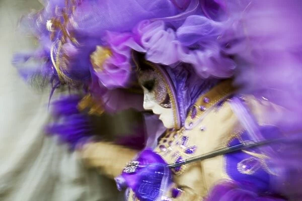 Venice, Veneto, Italy; A mask in movement on Piazza San Marco during Carnival