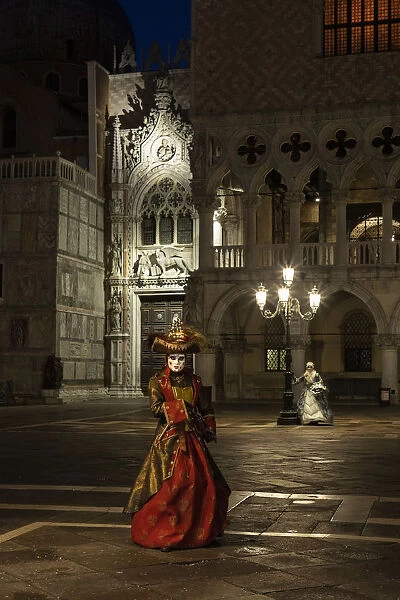A woman in costume poses in St. Marks square during the Venice Carnival, Venice