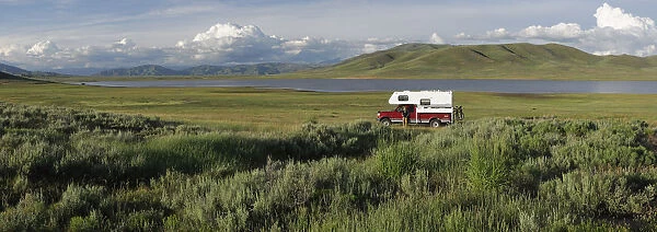 Woman standing next to her pick up camper, Little Camas Prarie Reservoir, Boise National