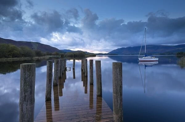 Wooden jetty and yacht on Derwent Water near Lodore, Lake District, Cumbria, England