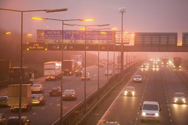 Cars driving on the M! motorway near Loughborough in evening fog