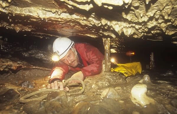 A caver in Easegill Caverns in the Yorkshire Dales, UK