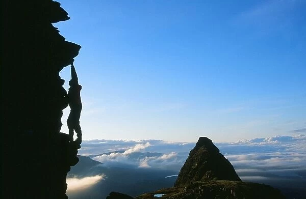 A climber on Suilven at dawn Scotland UK