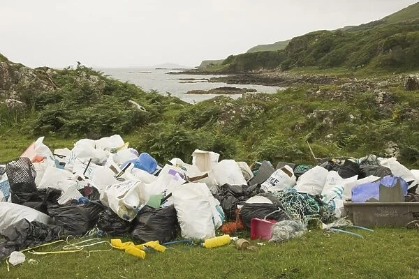 Piles of rubbish collected from beach beyond, Torloisk beach, Isle of Mull, Scotland (RR)