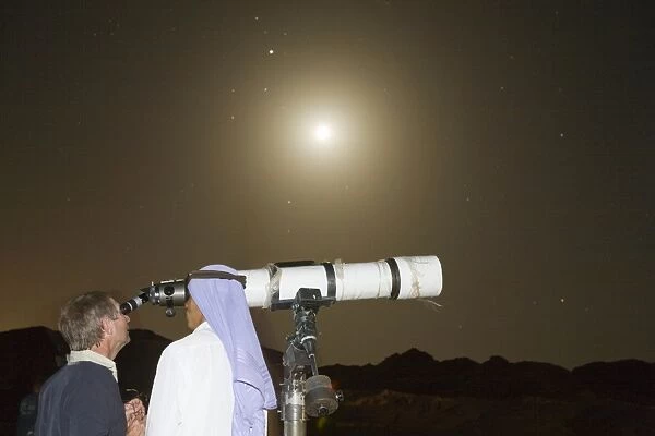 star gazing through a telescope with Bedouin arabs in the Sinai Desert near Dahab in Egypt