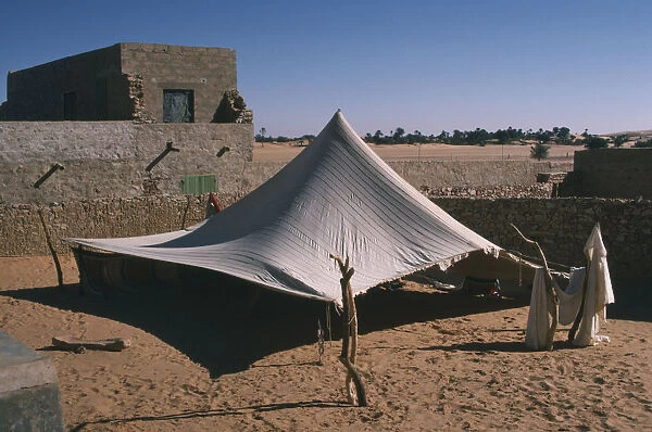 10007725. MAURITANIA Chinguetti Tent pitched near old buildings