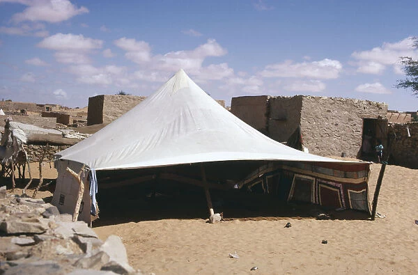 10007765. MAURITANIA Chinguetti Tent pitched near old buildings
